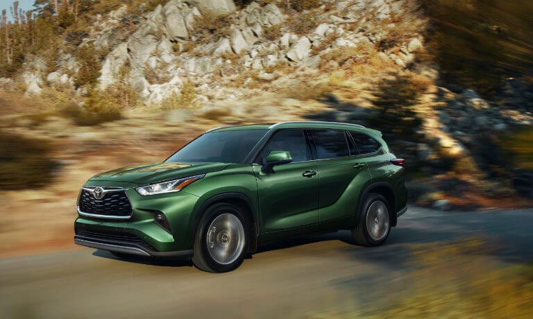 2023 Toyota Highlander exterior driving forest road